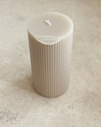 Damaged Ribbed Pillar Candle in Parchment
