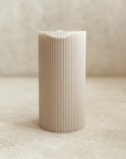 Damaged Ribbed Pillar Candle in Parchment